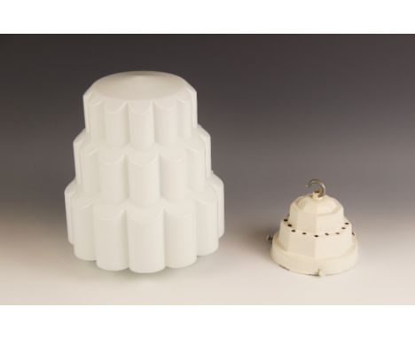 An Art Deco opaline glass light shade, of jelly mould form, with three graduated lobed tiers, complete with a stepped metal g
