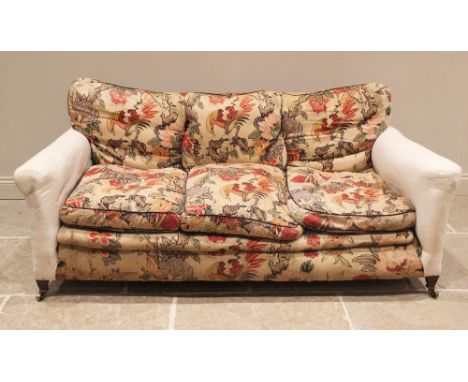 A late Victorian sofa in the manner of Howard & Sons, partially covered in William Morris type fabric, the sprung seat with a