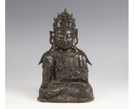 A Sino-Tibetan bronze figure of buddha, seated in dhyanasana, right hand in vitarka mudra, left hand in dhyana mudra holding 