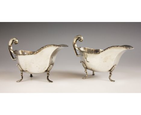 A pair of George V silver gravy boats, Thomas Latham &amp; Ernest Morton, Birmingham 1912, each of typical faceted form with 