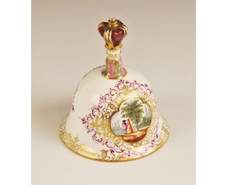 A Meissen porcelain bell, enamelled to each side with quatrefoil panels depicting courting couples, the handle modelled with 