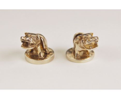 A pair of novelty silver menu-card holders, Boodle &amp; Dunthorne, London 1992, modelled as hippos upon a circular base, eac