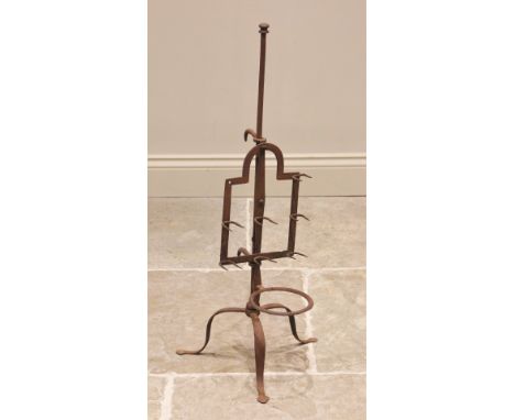 An early 19th century iron lark spit, the break-arch frame upon a tripod stand extending to spade feet, 85cm high 