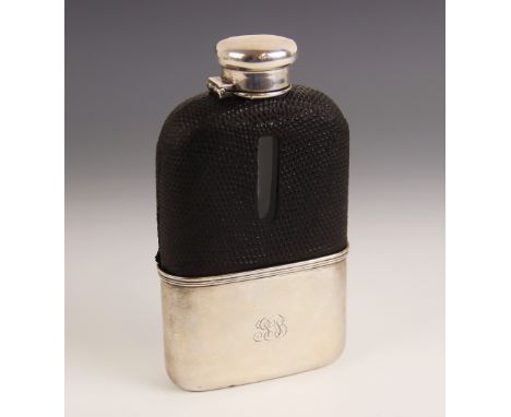 A silver mounted glass hip flask by Tiffany &amp; Co, the colourless glass body with black leather mount, plain polished silv