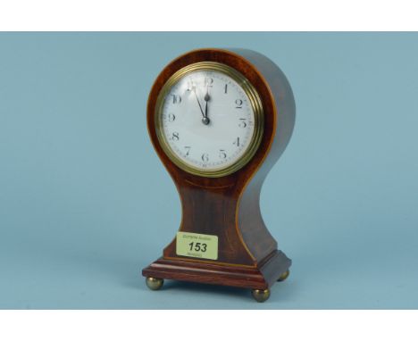 A French Edwardian inlaid mahogany balloon shaped mantel clock standing on brass ball feet