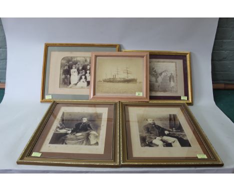 A pair of framed late 19th Century photograph portraits of a lady and gentleman, a framed portrait of servants and staff plus