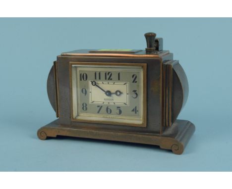 An American made 8 day mantel lighter clock by Ronson with two-tone copper finish in the Deco design