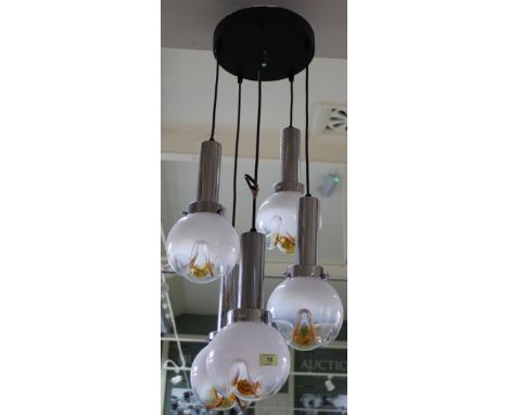 A stylish chrome and glass pendant light fitting having five Swedish hand blown glass shades, each light of a different lengt