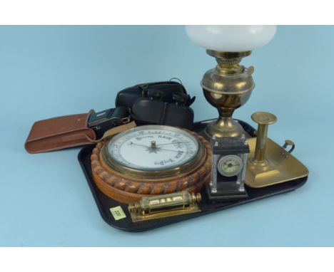 A brass oil lamp with shade, a brass chamberstick, an oak cased barometer, a vintage 'Ensign-Selfix 20' camera plus a clock a