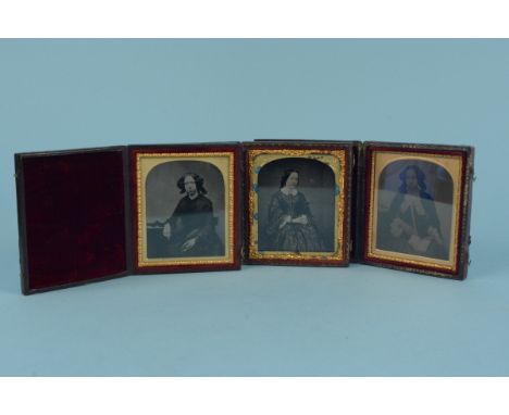 Three Victorian ambrotype cased photographs of ladies, Red Moroccan leather cases, one photo with hand coloured over decorati