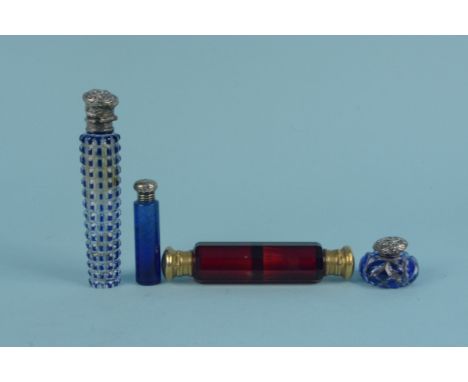 A Victorian ruby glass double ended scent bottle with gilded metal end caps (stoppers missing), a hobnail cut clear and blue 