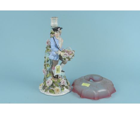 A late 19th Century Sitzendorf porcelain candlestick modelled as a gentleman with a basket of roses, 37cm high