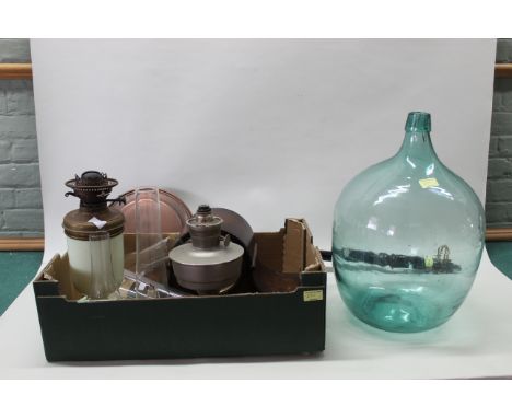A mixed lot including 1930's oak striking/chiming mantel clock, two oil lamps and chimneys, a green glass carboy plus a 19th 
