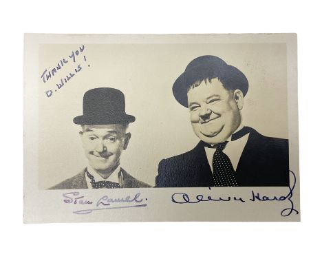 Stan Laurel and Oliver Hardy signatures on head and shoulder portrait of the two comedians inscribed 'THANK YOU D. WILLIS' 9 