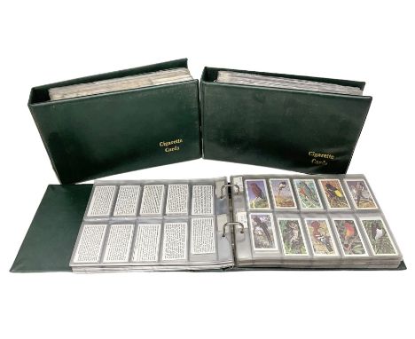 Three modern loose leaf albums containing a large quantity of cigarette and trade cards by Wills, Players, Godfrey Phillips, 