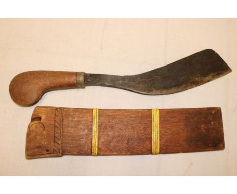 A Borneo dagger with crude 11" single edged blade and polished wood hilt in teak scabbard 