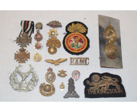A selection of various military badges and insignia including Northumberland Fusiliers fur cap grenade adapted on a plaque, s