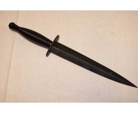 A post-War Commando dagger by W Rodgers of Sheffield in blackened steel mounts 