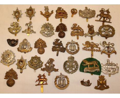 A selection of over 30 various British Infantry cap badges including Kings Own, Dorset Regiment, Wiltshire Regiment, Bedfords