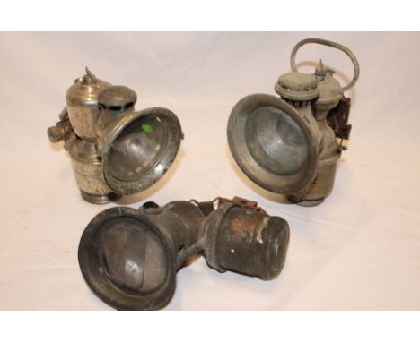 Three various old carbide motorcycle lamps by Miller, Lucas etc
