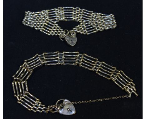 A five-bar gate bracelet and a six-bar gate bracelet, each with heart-shaped clasp, approximately 27 grams gross.