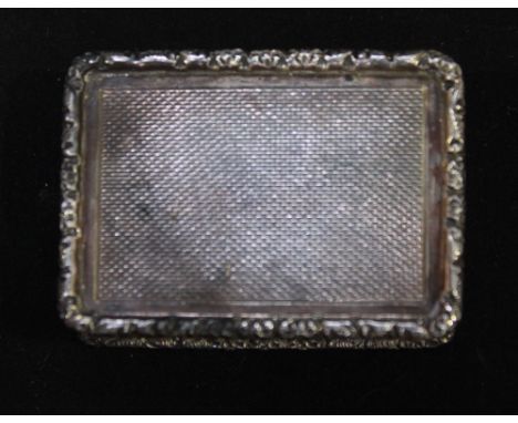 A silver and silver-gilt snuff or pill box, of rectangular form with floral cast rim and engine-turned decoration, Birmingham