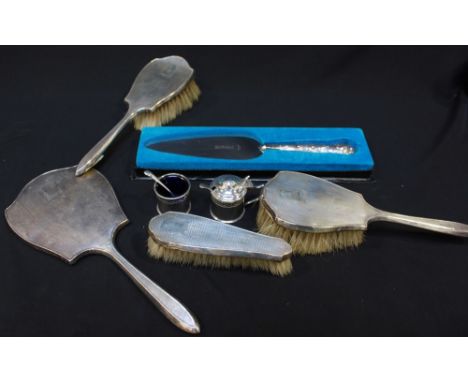 A pair of silver mustard and salt pots, Birmingham 1918/19, together with an engine turned silver backed brush set and a silv