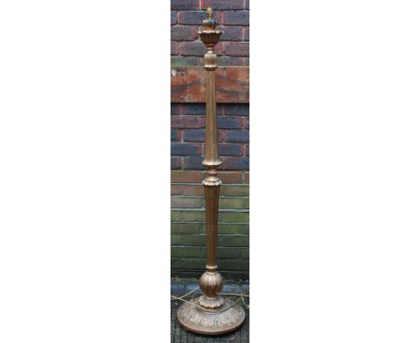 A gilt-painted turned and fluted standard lamp with foliate carved circular base. 