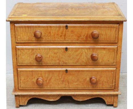 A 19th century pine chest of drawers with faux-graining and ebony-line stringing, three long drawers with turned pulls, raise