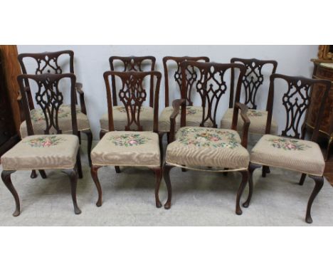 A set of eight mahogany Chippendale style dining chairs comprising two carvers and six standard chairs with pierced vase shap