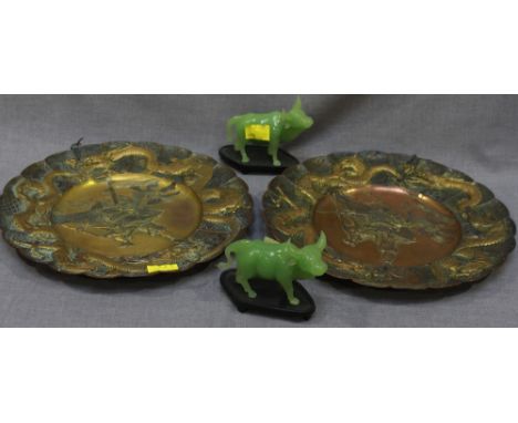 Two modern jade carved figures of cows, on wooden stands, 11cm long, together with a pair of Japanese embossed and gilded cop