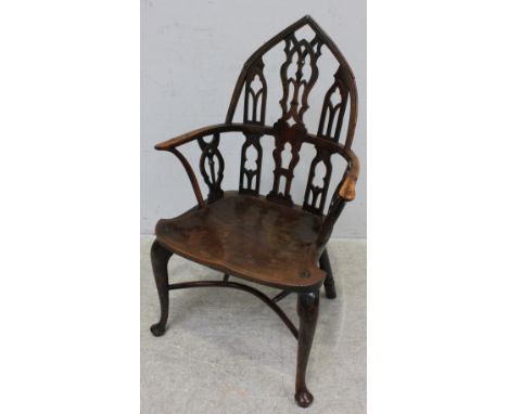  A George III yew and elm Windsor chair in the Strawberry Hill Gothic style, the back with pierced and carved tracery, shaped