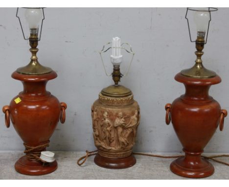 A pair of turned stained-wood table lamps of baluster form with ring handles, together with a painted plaster table lamp moul