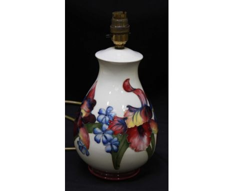 A Moorcroft "Orchid pattern" table lamp of baluster form, WM mark and part paper label, 23cm high.  Condition:  glaze crazing