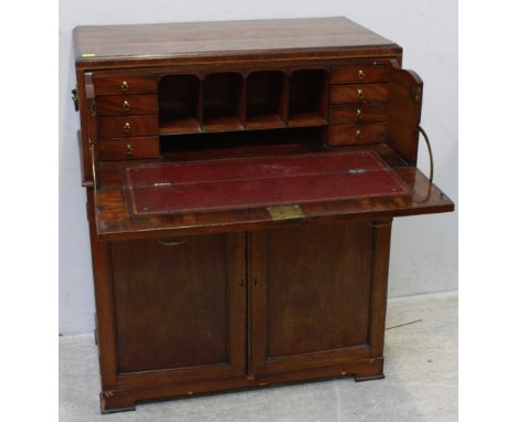 A 19th century mahogany secretaire cupboard, the separate secretaire top with hinged and sliding scribe enclosing drawers and