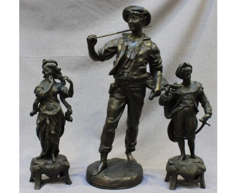 A pair of patinated spelter figures of a couple in Renaissance dress, he with sword and oil lamp, she in contemplation, 36cm 