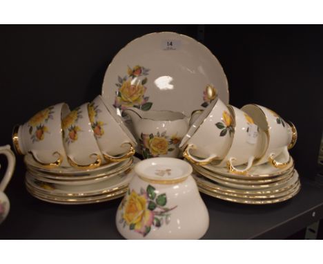 A vintage Delphine bone china part tea set, containing cups and saucers, milk jug and sugar basin, having yellow rose transfe