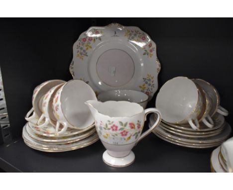 A part tea set Having floral transfer pattern in pastel colours and gilt edging, includes cake plate and sugar basin, cups an