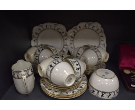 A Foley china part tea service having transfer pattern of silhouetted pixies and fairies with gilt edge, includes sugar basin