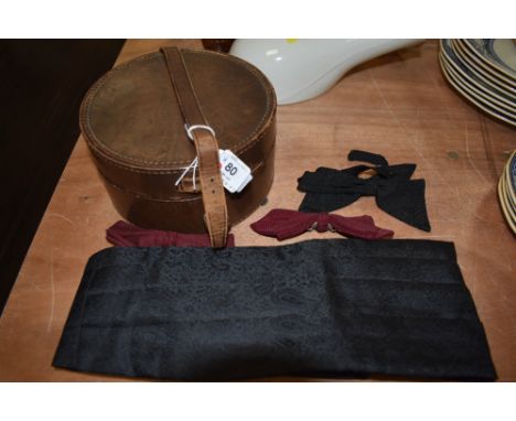 A vintage collar box and a selection of bow ties and cummerbund.