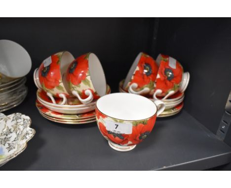 A cheerful collection of cups and saucers and side plates having bright red poppy pattern, Staffordshire England.