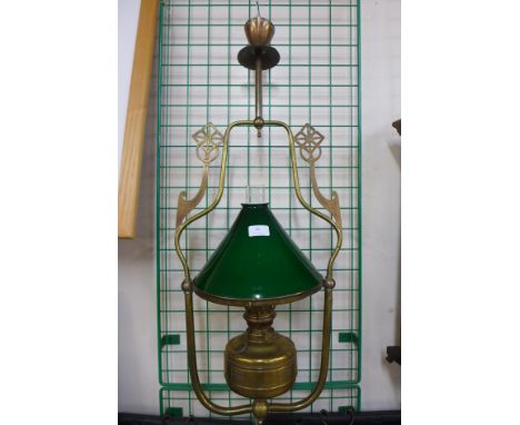A brass ceiling light with green glass shade 