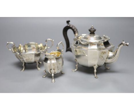 A late Victorian three-piece silver tea service of shaped stylised outline, J. R. Ltd, Birmingham 1898, gross 16.16oz