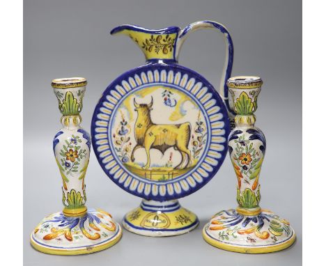 An Italian maiolica flask, height 30cm, and a pair of French faience candlesticks