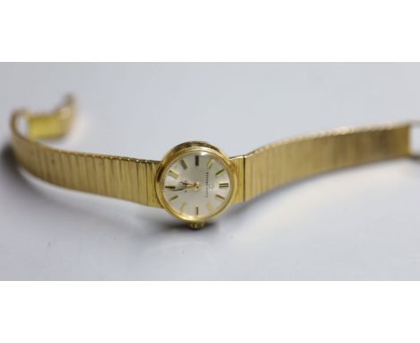 A lady's 9ct gold Eterna-Matic manual wind wrist watch, on a 9ct gold bracelet, overall 16cm, gross 30.7 grams.