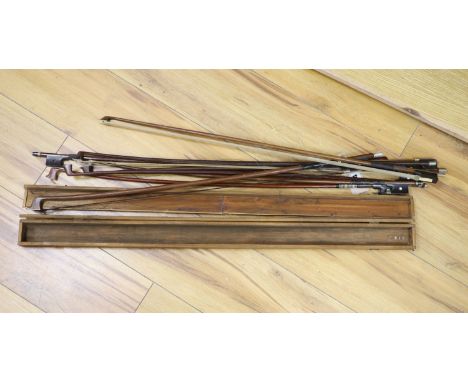 A quantity of violin bows and box, together with a print