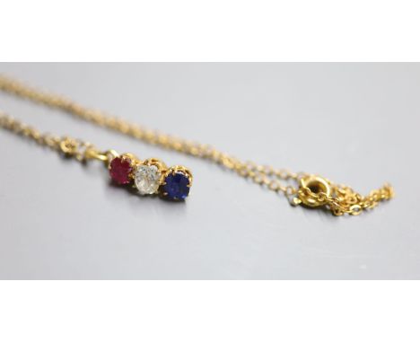 A yellow metal, ruby, diamond and sapphire set line pendant, 14mm, on a yellow metal chain, 38cm, gross 2.4 grams, diamond ap