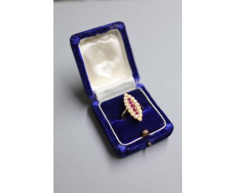 A yellow metal, ruby and split pearl cluster set marquise shaped dress ring, size Q, gross 5.8 grams.CONDITION: Overall condi