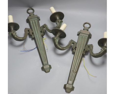 A pair of bronze two branch wall lights, length 52cm