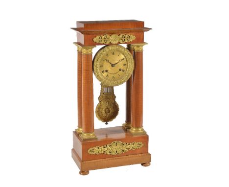 A French Charles X ormolu mounted figured satinwood portico mantel clock, Bechot, Brussels, early 19th century   The circular